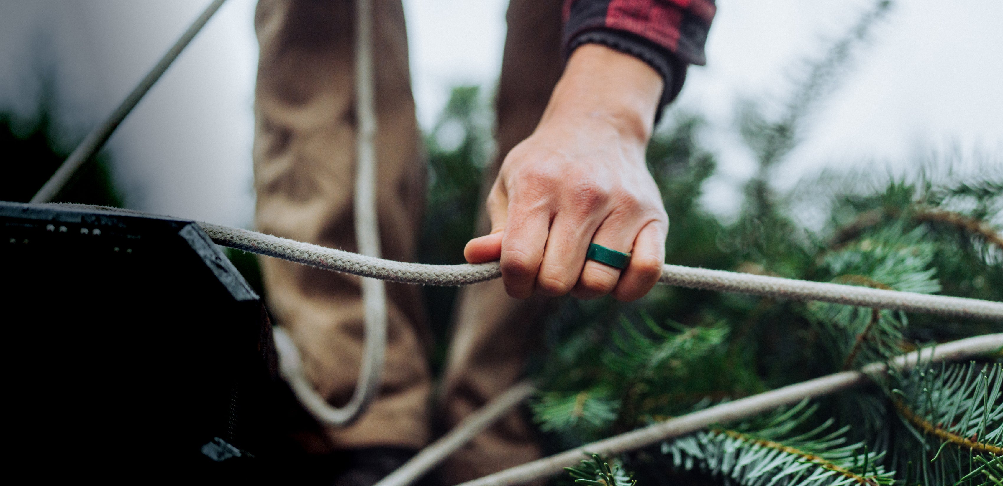 man's hand with green groove ring